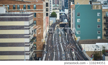 Empty train tracks in city, travel, transportation with aerial of buildings lining railroad, Chicago Empty train tracks in city, travel, transportation with aerial of buildings lining railroad, Chicago 110244351