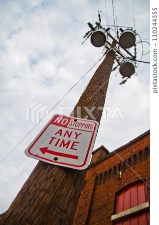No Stopping Sign and Complex Urban Infrastructure Against Overcast Sky 110244355