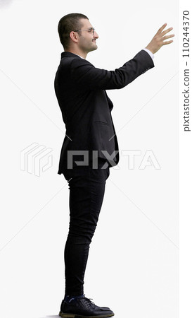 young man in full growth. isolated on white background pointing with finger 110244370