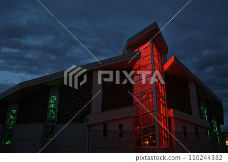 Twilight Glow on Modern Glass Church with Red and Green Illumination Twilight Glow on Modern Glass Church with Red and Green Illumination 110244382