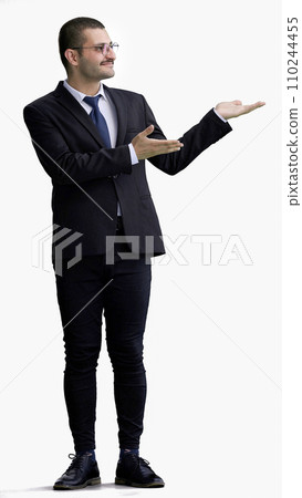 young man in full growth. isolated on white background demonstrates with hands young man in full growth. isolated on white background demonstrates with hands 110244455