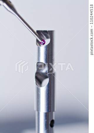 Close-up of Metrology CMM Probe Inspecting Metal Part for Minute Flaws 110244518