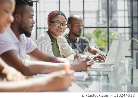 Young man using laptop with female student watching and smiling Young man using laptop with female student watching and smiling 110244538