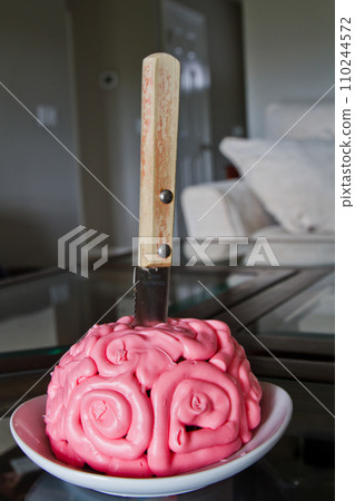 Brain-Themed Pink Cake with Knife in Domestic Setting Brain-Themed Pink Cake with Knife in Domestic Setting 110244572
