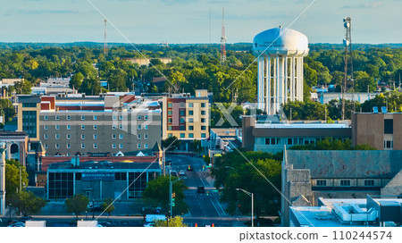 Downtown Muncie, IN aerial at sunset with city buildings leading to American Water tower Downtown Muncie, IN aerial at sunset with city buildings leading to American Water tower 110244574