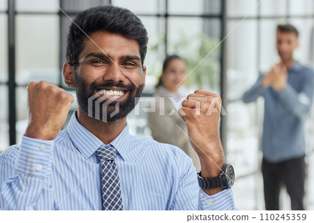 a man holding his hand up a gesture of triumph and victory. a man holding his hand up a gesture of triumph and victory. 110245359