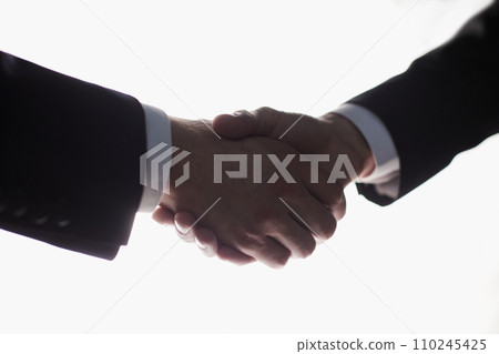 Two businessmen shake hands for agreement. Isolated image with white background, Business concept Two businessmen shake hands for agreement. Isolated image with white background, Business concept 110245425
