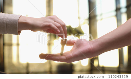 From hand to hand. Close up shot of hand of female seller owner 110245529