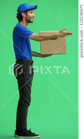 full-length male courier holding a box on a green background 110246075