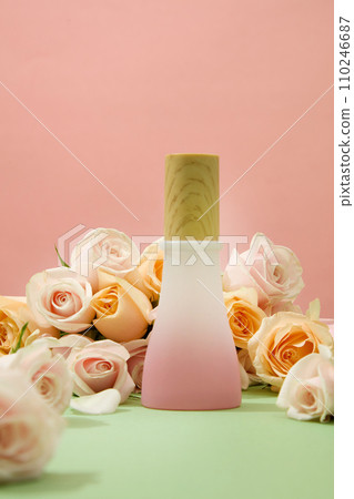 Pink background with roses and a bottle of homemade cosmetics on display. Roses contain phytochemicals such as nerol, geraniol and citronellol that help fight many germs and bacteria. Pink background with roses and a bottle of homemade cosmetics on display. Roses contain phytochemicals such as nerol, geraniol and citronellol that help fight many germs and bacteria. 110246687