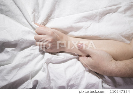 Lovers' hands squeeze each other in bed, romantic and passionate make love 110247524