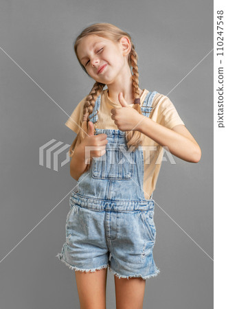 A little girl shows the ok sign with her hand A little girl shows the ok sign with her hand 110247548