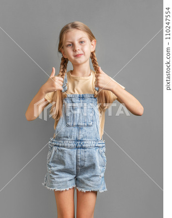 A little  girl shows the ok sign with her hand 110247554