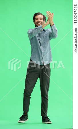 man in full growth. isolated on green background applauds man in full growth. isolated on green background applauds 110247968