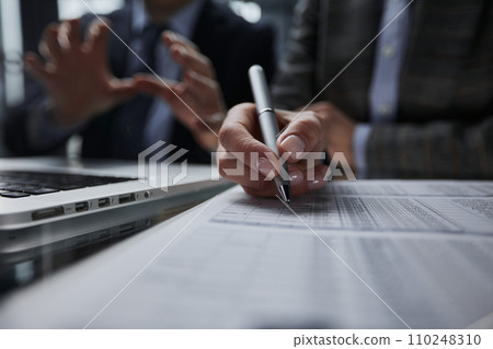 man looking through to documents. Business assessment and audit. man looking through to documents. Business assessment and audit. 110248310