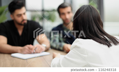 businessman a meeting with his colleagues in an office, while sitting with his team in a meeting room. businessman a meeting with his colleagues in an office, while sitting with his team in a meeting room. 110248318