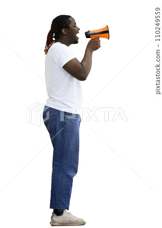 A full-length man in a white T-shirt on a White background speaks through a megaphone, in profile 110249559