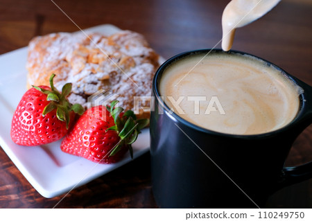 latte cappuccino stir with a spoon thick foam coffee with milk Eating freshly baked French croissants for breakfast studio photography latte cappuccino stir with a spoon thick foam coffee with milk Eating freshly baked French croissants for breakfast studio photography 110249750