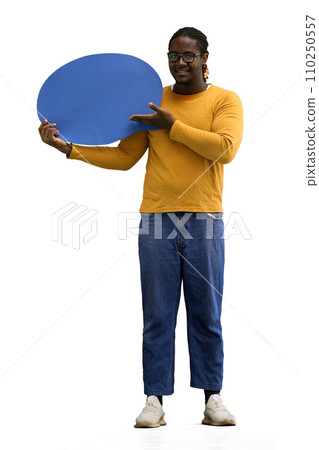 A man in a yellow sweater on a White background holds a blue comment sign A man in a yellow sweater on a White background holds a blue comment sign 110250557