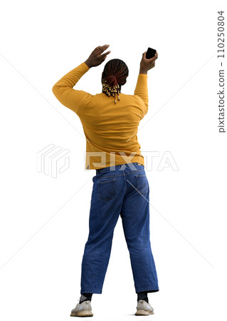 A man in a yellow jacket on a White background waves a phone, back view A man in a yellow jacket on a White background waves a phone, back view 110250804