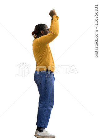 A man in yellow jacket on a White background raised his hands up in profile A man in yellow jacket on a White background raised his hands up in profile 110250831