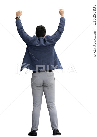 A man in a jacket on a White background raised his hands up. Back view 110250833
