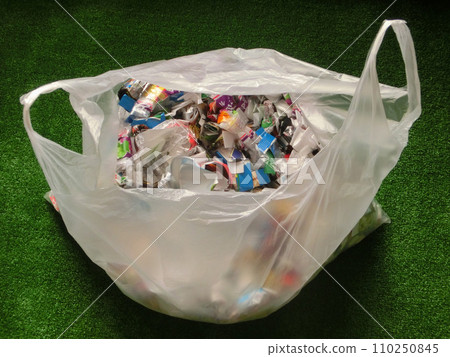 A plastic bag containing recyclable plastic waste placed on artificial grass A plastic bag containing recyclable plastic waste placed on artificial grass 110250845