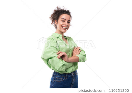 young positive brunette businesswoman with curly hair tied up in a ponytail in a light green shirt young positive brunette businesswoman with curly hair tied up in a ponytail in a light green shirt 110251200