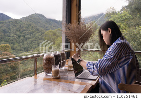 digital nomad concept asian freelancer woman use laptop to work at mountain view of coffeeshop 110251461