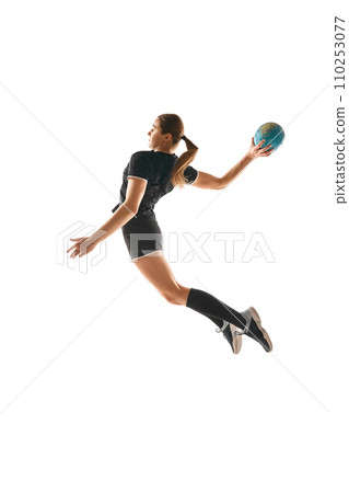 Determined woman, handball player in action, exhibiting focus and energy during training against white background. Concept of sport. Determined woman, handball player in action, exhibiting focus and energy during training against white background. Concept of sport. 110253077