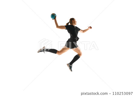 Female handball enthusiast executing precise throw, emphasizing the sport's energy and athleticism against white background. Concept of sport and training. 110253097