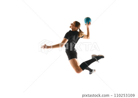 Determined female athlete practicing handball moves with concentration and dedication against white studio background. Concept of sport and action. Determined female athlete practicing handball moves with concentration and dedication against white studio background. Concept of sport and action. 110253109