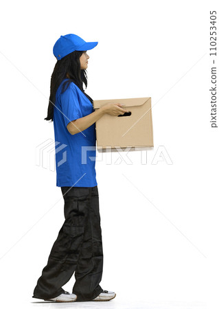 The delivery girl, on a white background, in full height, gives a box The delivery girl, on a white background, in full height, gives a box 110253405