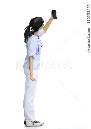 Doctor girl, on a white background, full-length, with a phone 110253463