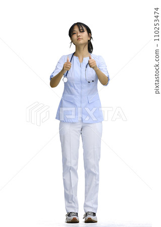 The doctor's girl, on a white background, in full height, shows her thumbs up The doctor's girl, on a white background, in full height, shows her thumbs up 110253474