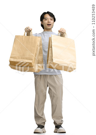 A guy in a gray T-shirt, on a white background, full-length, with pacts A guy in a gray T-shirt, on a white background, full-length, with pacts 110253489