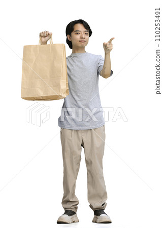 A guy in a gray T-shirt, on a white background, full-length, with pacts 110253491