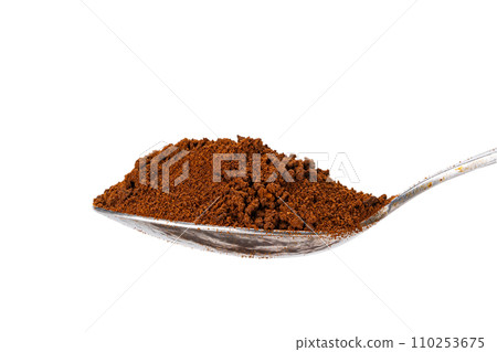 Side view of organic instant coffee powder in metal teaspoon. 110253675