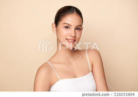 Beautiful young asian woman with clean fresh skin on beige background, Face care, Facial treatment, Cosmetology, beauty and spa, Asian women portrait. Beautiful young asian woman with clean fresh skin on beige background, Face care, Facial treatment, Cosmetology, beauty and spa, Asian women portrait. 110253804