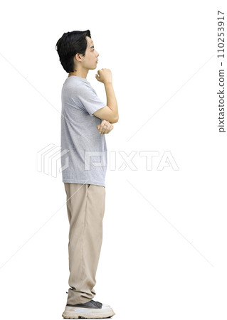A guy in a gray T-shirt, on a white background, in full height, thinks A guy in a gray T-shirt, on a white background, in full height, thinks 110253917