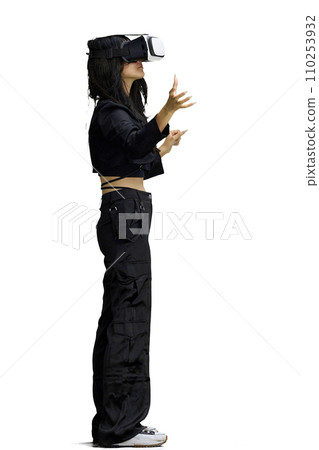 A woman in black clothes, on a white background, full-length, wearing VR glasses A woman in black clothes, on a white background, full-length, wearing VR glasses 110253932