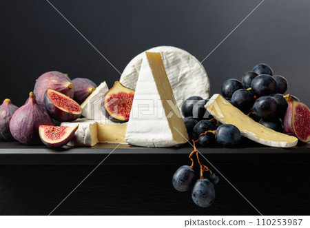 Camembert cheese with figs and grapes. Camembert cheese with figs and grapes. 110253987