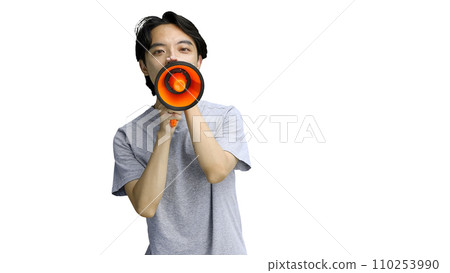 A guy in a gray T-shirt, on a white background, close-up, with a megaphone A guy in a gray T-shirt, on a white background, close-up, with a megaphone 110253990