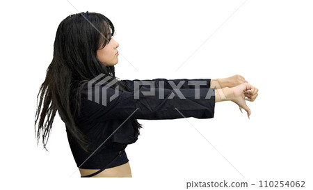 A girl in black clothes, on a white background, close-up, shows her thumbs down 110254062