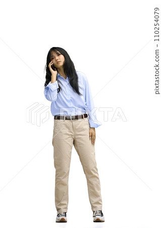 A girl in a blue shirt, on a white background, full-length, with a phone A girl in a blue shirt, on a white background, full-length, with a phone 110254079