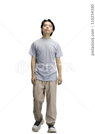 A guy in a gray T-shirt, on a white background, full-length 110254380