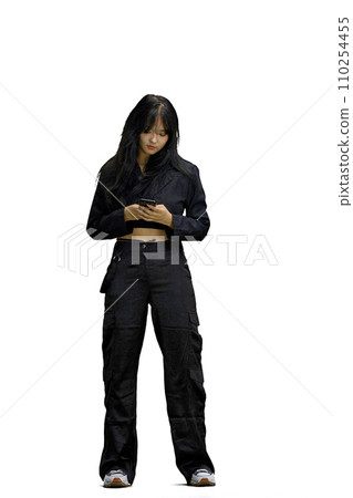 A woman in black clothes, on a white background, full-length, with a phone A woman in black clothes, on a white background, full-length, with a phone 110254455