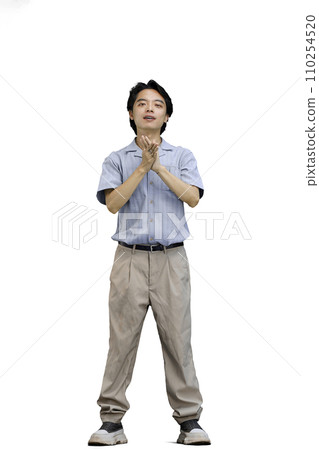 A guy in a blue shirt, on a white background, in full height, folded his arms 110254520