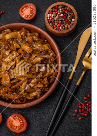 Delicious asian udon dish with vegetables, mushrooms, salt and spices 110255096