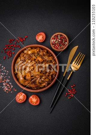 Delicious asian udon dish with vegetables, mushrooms, salt and spices 110255103